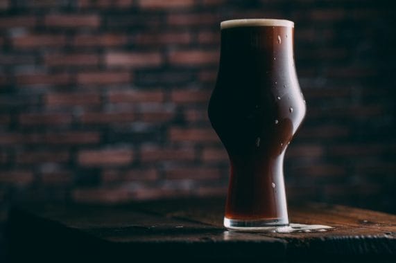 Stout beer sits on a table. 